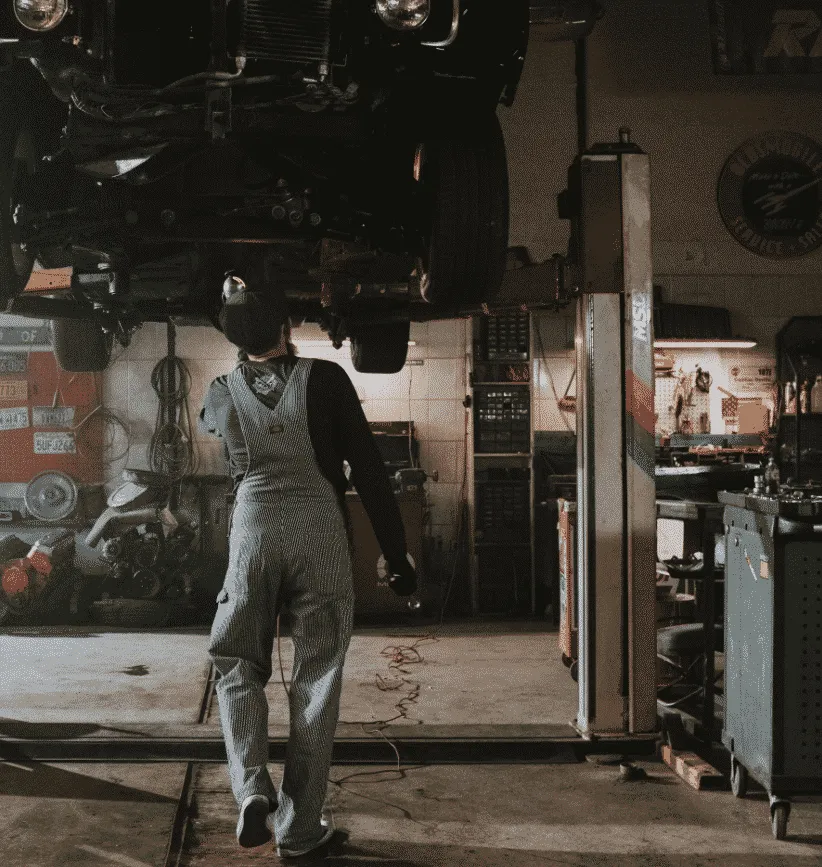 Car on lift with mechanic