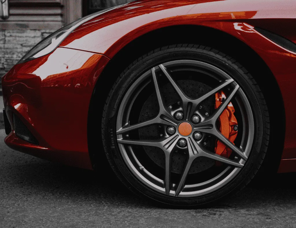 red sports car with orange caliper