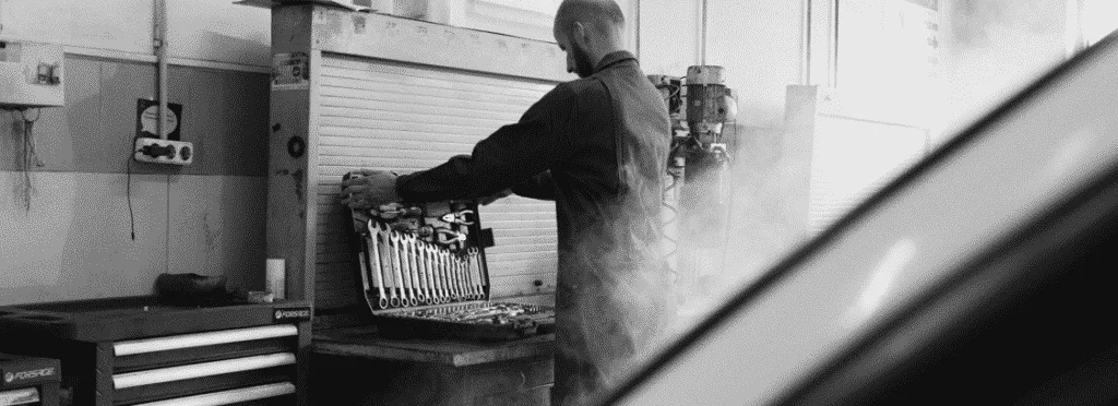 mechanic in front of car overheating