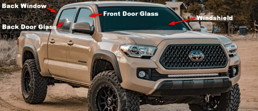 Tan 4 door Toyota Tacoma with listed glass parts