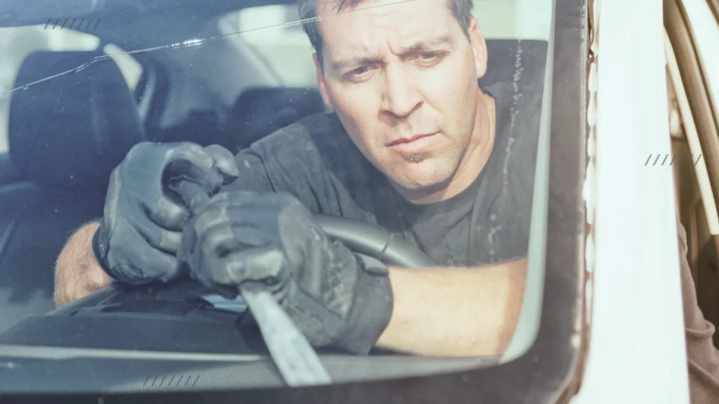 man removing front windshield