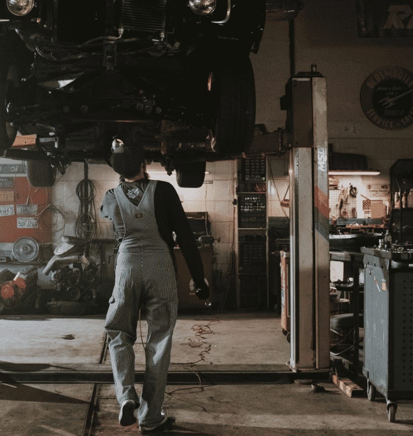 Car on lift with mechanic